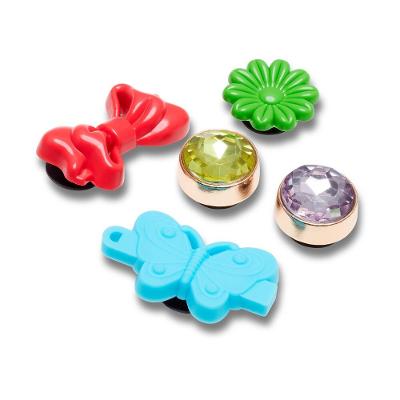 Jibbitz™ pedras e laço pack 5 unico